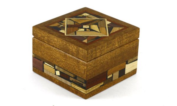 Small wooden box decorated with wood mosaics. No stains or dyes.Small wooden box decorated with multi wood mosaics on top and sides. No stains or dyes, just the natural colors of each wood.